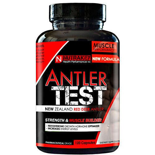 A bottle of Nutrakex Antler Test dietary supplement capsules, featuring a black label with red and white text and graphics, on a plain white background.