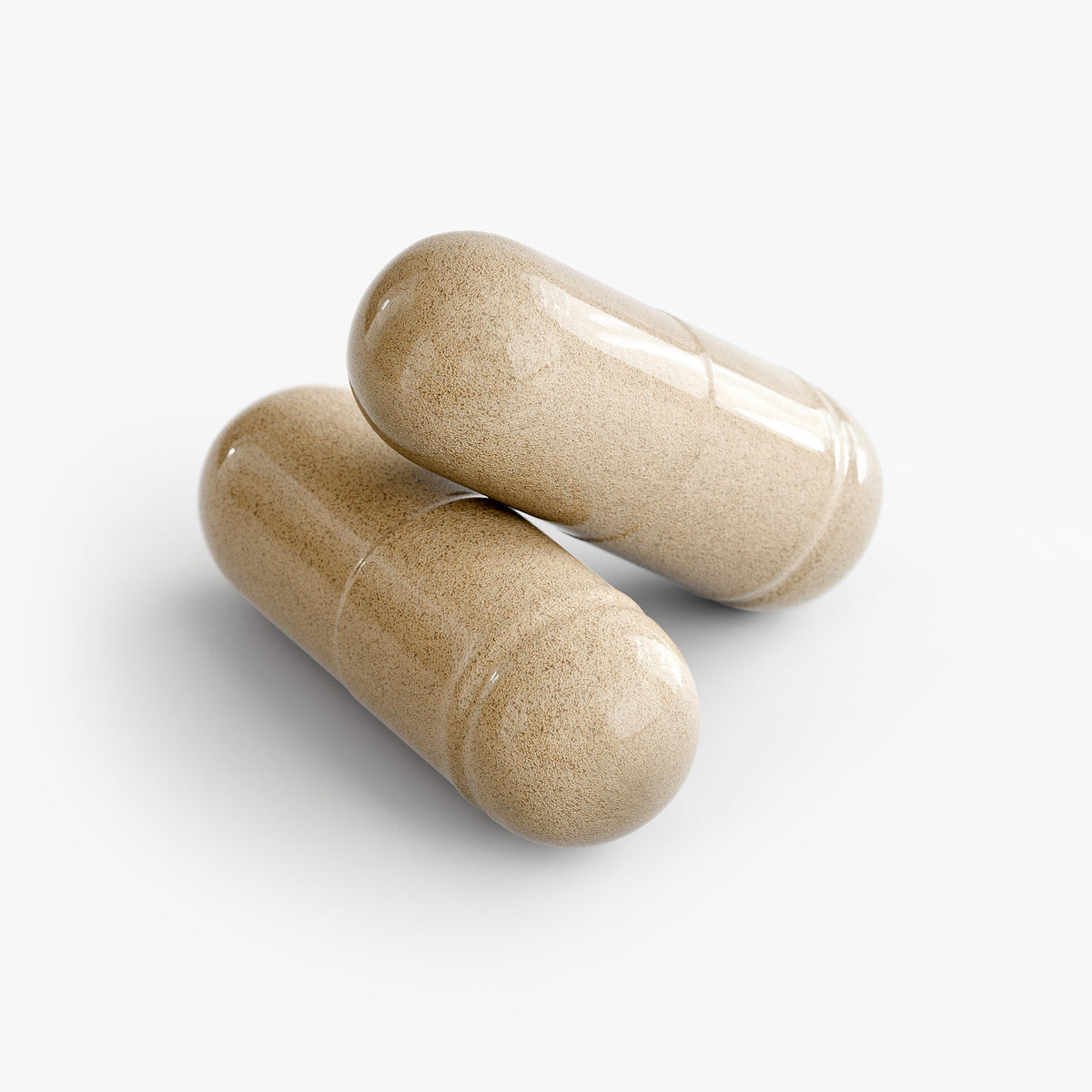 Two beige capsules on a white background