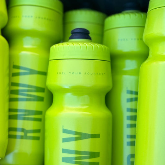 Stack of yellow water bottles with 'RWY' branding.