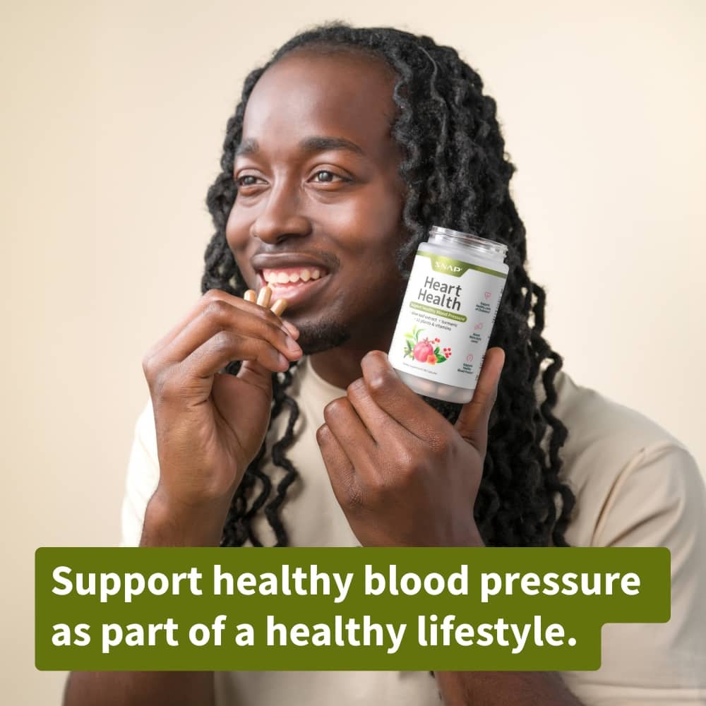 Person holding a supplement bottle with text about supporting healthy blood pressure.