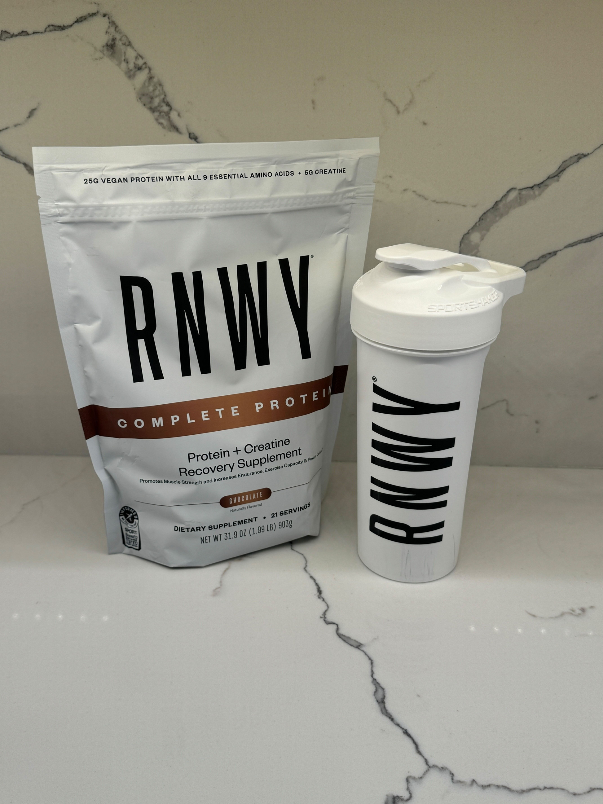 RNWV protein powder package and shaker bottle on a marble surface